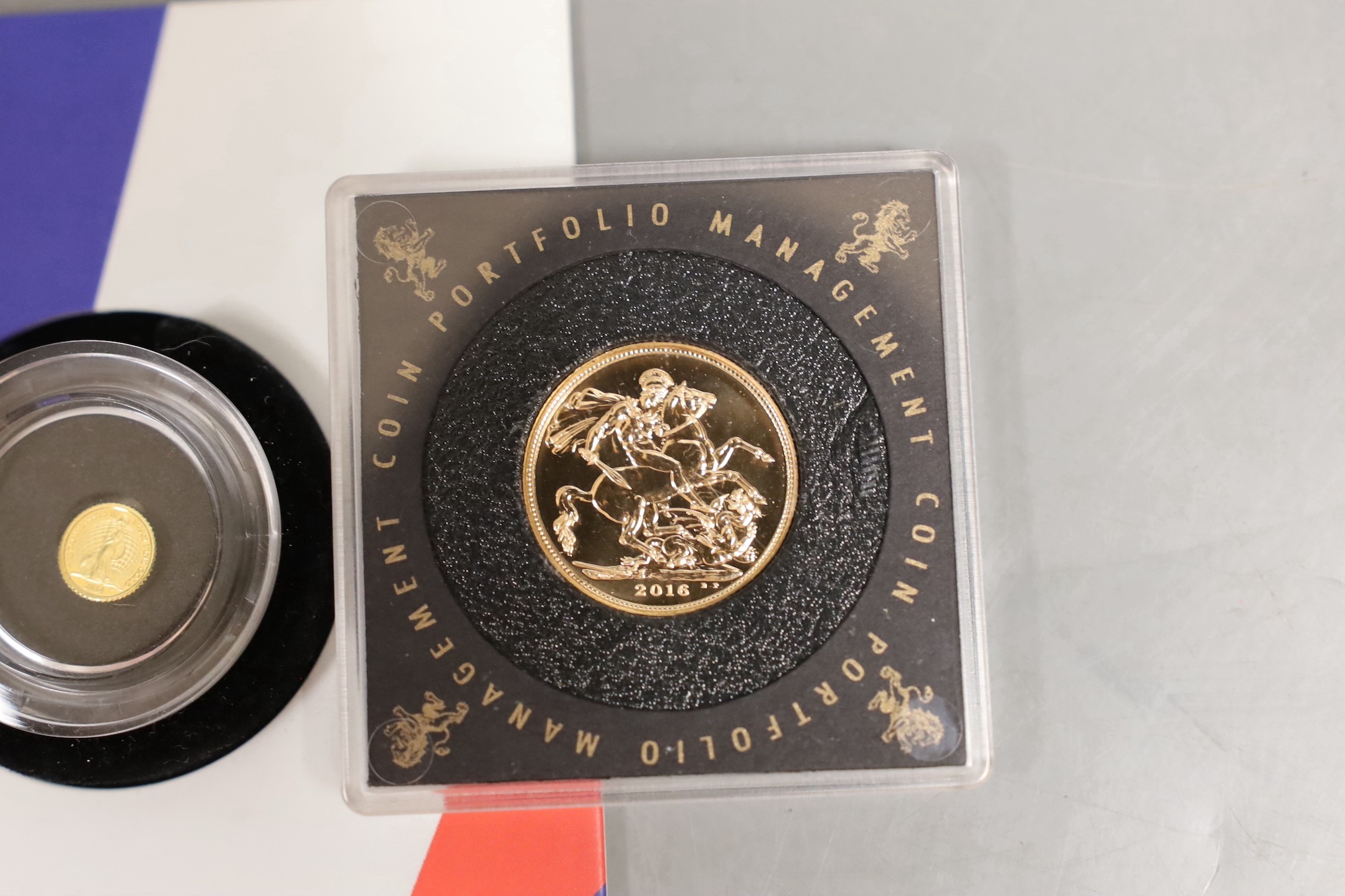 A UK 2016 gold sovereign, in a capsule and a Royal Mint 2014 Britannia 40th ounce gold proof coin (2)